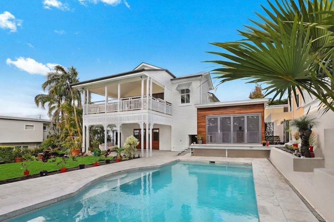 Same house with lush green lawn after AI lawn enhance