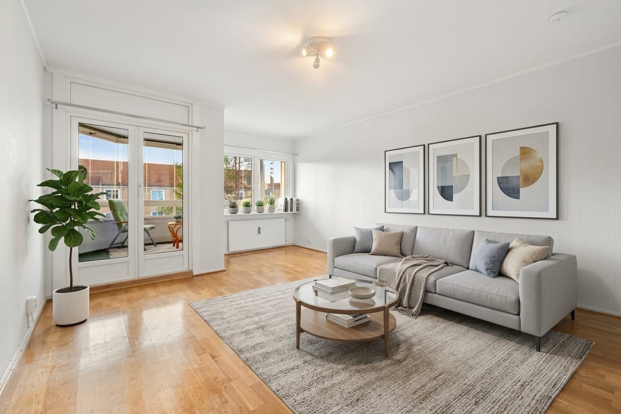 Empty living room virtually staged with a gray sofa, rug and art